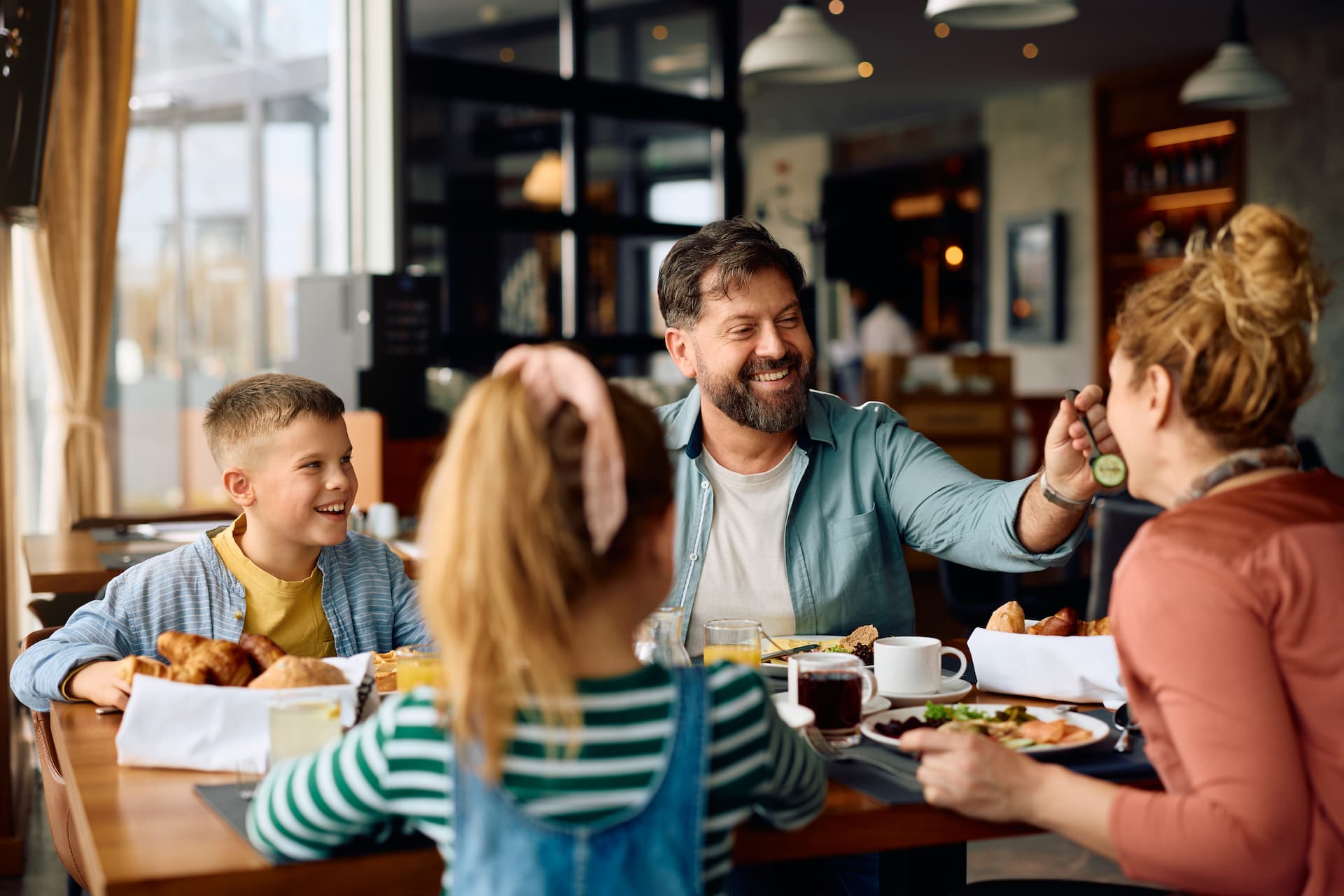 happy family having fun while eating breakfast in 2026 03 16 03 27 25 utc 1